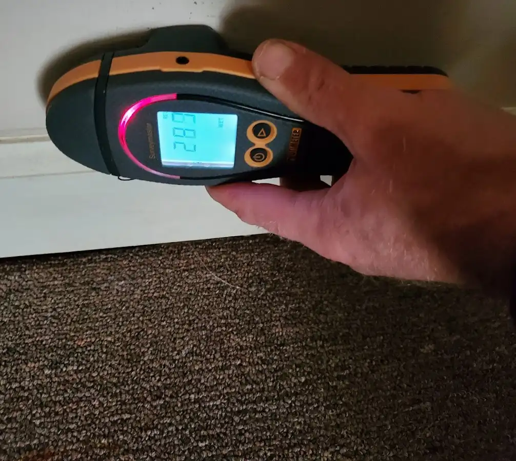 Moisture detection at baseboard during Storm Damage Restoration in Providence Village